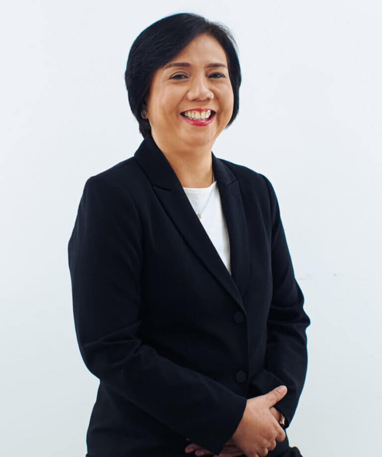 Professional headshot of a smiling businesswoman posing in a formal black suit jacket.